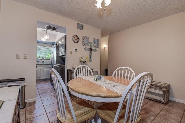 1500 Sunset Rd Unit G4, Tarpon Springs, FL 34689 - dining area featuring visible vents, baseboards, a textured ceiling, and light tile patterned flooring