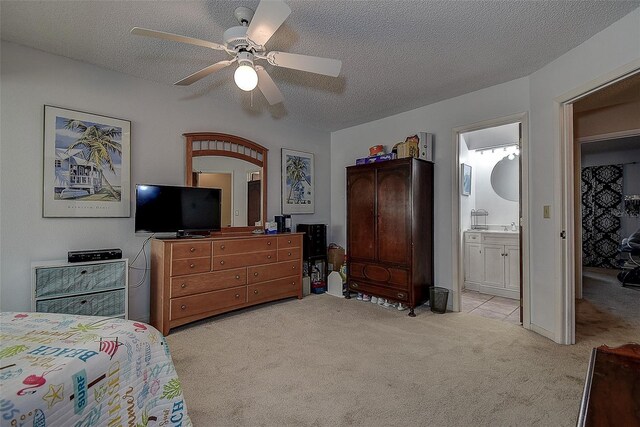 1500 Sunset Rd Unit G4, Tarpon Springs, FL 34689 - bedroom featuring light colored carpet, ceiling fan, ensuite bathroom, and a textured ceiling