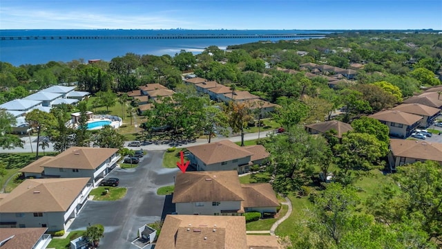 drone / aerial view with a water view and a residential view