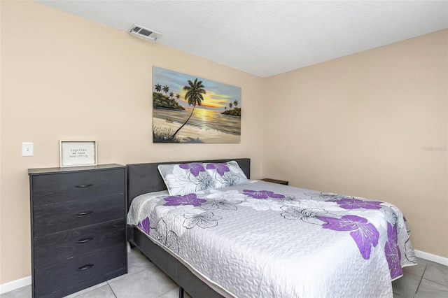 bedroom featuring visible vents, tile patterned floors, and baseboards