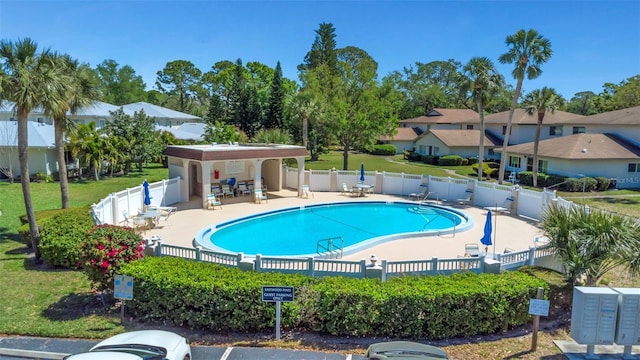pool featuring fence, a patio area, and mail area