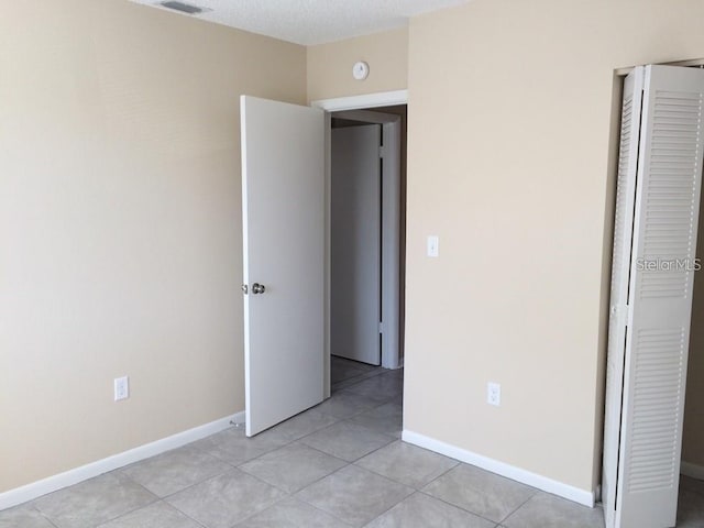 1830 Bough Ave Unit 2, Clearwater, FL 33760 - unfurnished bedroom with light tile patterned floors and a closet
