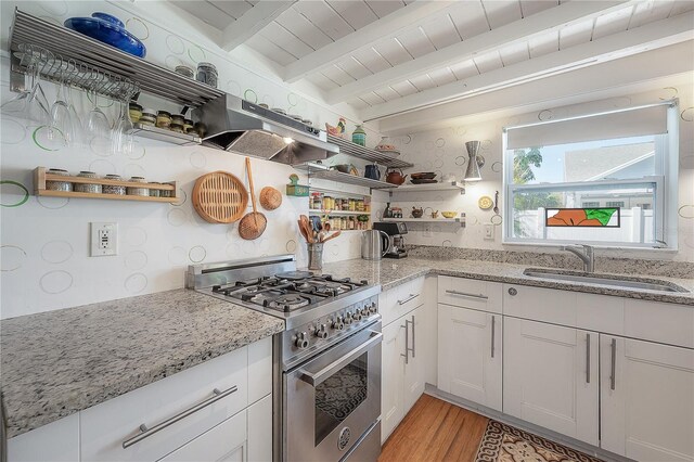 604 W Hilda St, Tampa, FL 33603 - kitchen with stainless steel range, under cabinet range hood, a sink, open shelves, and light wood-type flooring