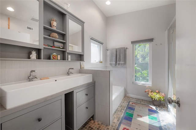 604 W Hilda St, Tampa, FL 33603 - bathroom with vanity, a bath, baseboards, recessed lighting, and tile patterned floors