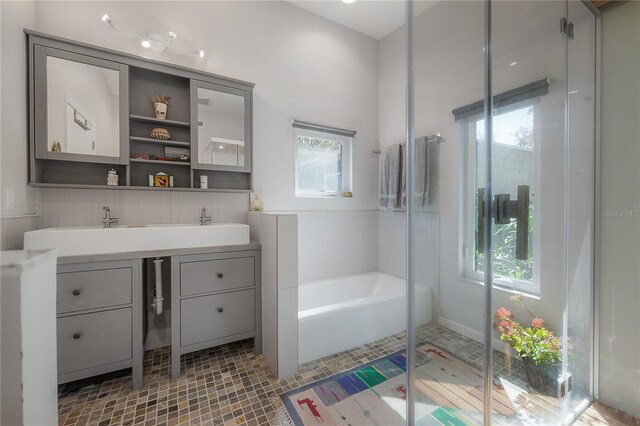 604 W Hilda St, Tampa, FL 33603 - bathroom with vanity, a bath, and a stall shower