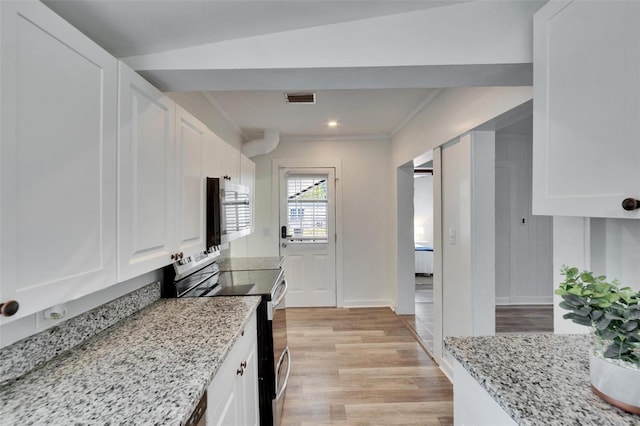 1138 Howard St, Clearwater, FL 33756 - kitchen with light wood-type flooring, white cabinets, appliances with stainless steel finishes, and visible vents