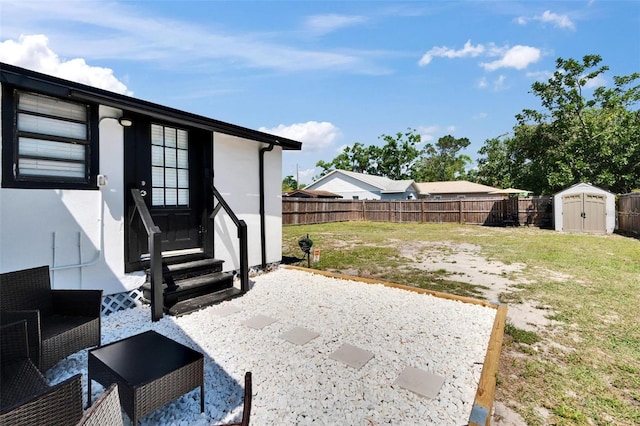 1138 Howard St, Clearwater, FL 33756 - view of patio / terrace featuring an outbuilding, a fenced backyard, a storage shed, and entry steps