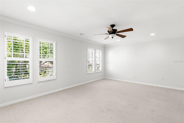 empty room with baseboards, a ceiling fan, crown molding, recessed lighting, and light carpet