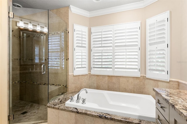 bathroom with vanity, plenty of natural light, a stall shower, and a garden tub