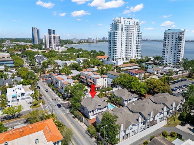 birds eye view of property with a water view and a view of city
