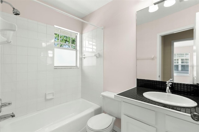 bathroom with toilet, shower / tub combination, and vanity