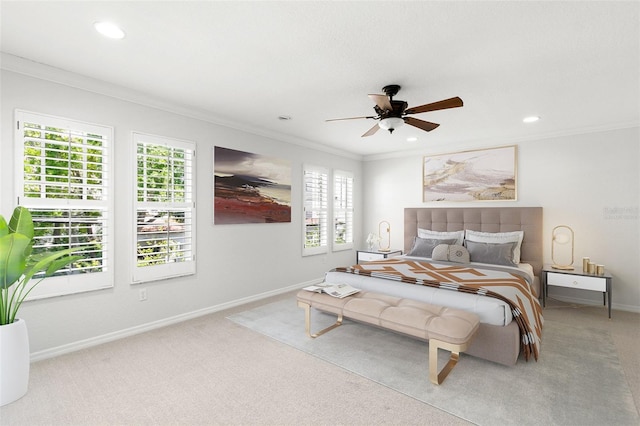 carpeted bedroom featuring recessed lighting, baseboards, crown molding, and a ceiling fan