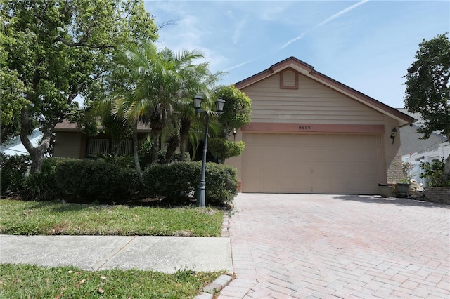 8609 Thimbleberry Ln, Tampa, FL 33635 - view of front of house with a garage and decorative driveway