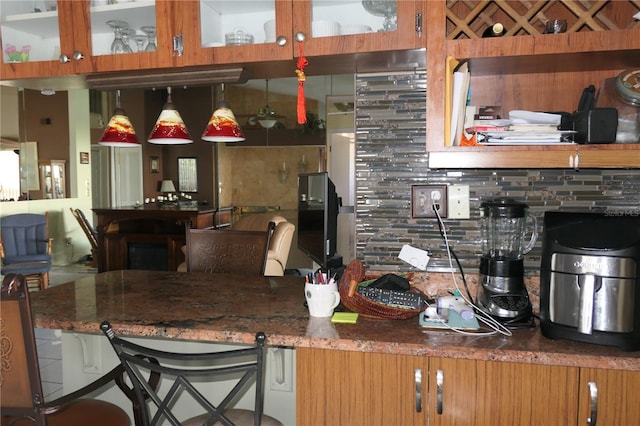 8609 Thimbleberry Ln, Tampa, FL 33635 - kitchen with glass insert cabinets, a kitchen breakfast bar, and backsplash