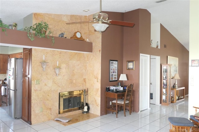8609 Thimbleberry Ln, Tampa, FL 33635 - living area with light tile patterned floors, ceiling fan, a premium fireplace, and a high ceiling