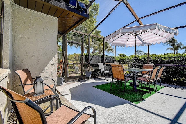 10 Arbor Ln, Oldsmar, FL 34677 - view of patio featuring outdoor dining space and glass enclosure