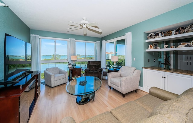 4801 Osprey Dr S Unit 508, Saint Petersburg, FL 33711 - living area with baseboards, ceiling fan, and light wood-style floors