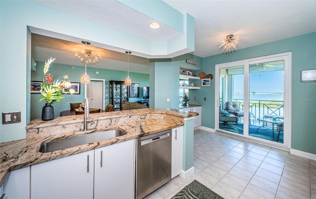 4801 Osprey Dr S Unit 508, Saint Petersburg, FL 33711 - kitchen with a sink, white cabinetry, light stone countertops, stainless steel dishwasher, and decorative light fixtures