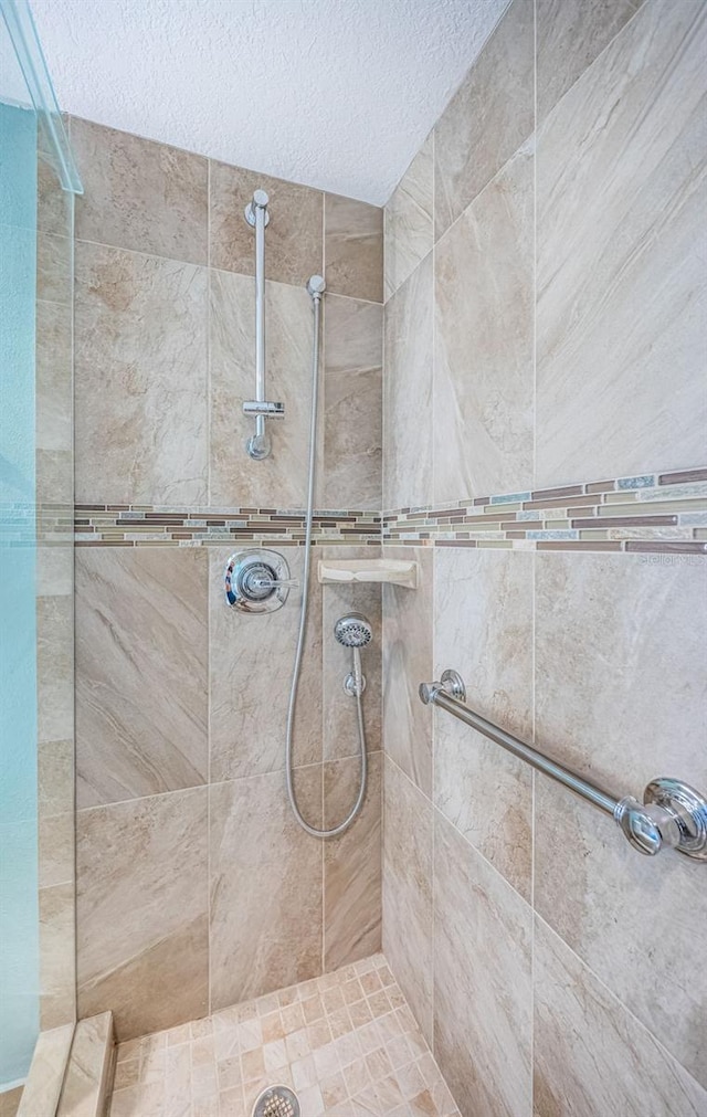 4801 Osprey Dr S Unit 508, Saint Petersburg, FL 33711 - full bathroom with a textured ceiling and a tile shower