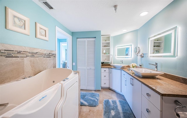 4801 Osprey Dr S Unit 508, Saint Petersburg, FL 33711 - bathroom featuring vanity, a tub with jets, tile patterned floors, visible vents, and a closet
