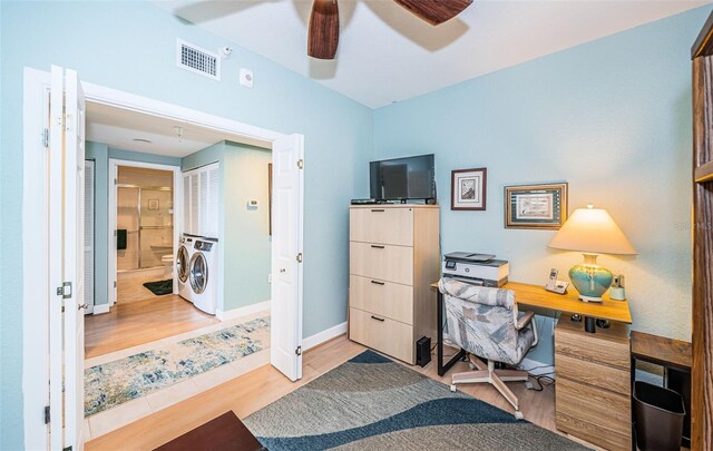 4801 Osprey Dr S Unit 508, Saint Petersburg, FL 33711 - office area featuring visible vents, baseboards, ceiling fan, wood finished floors, and washer / dryer