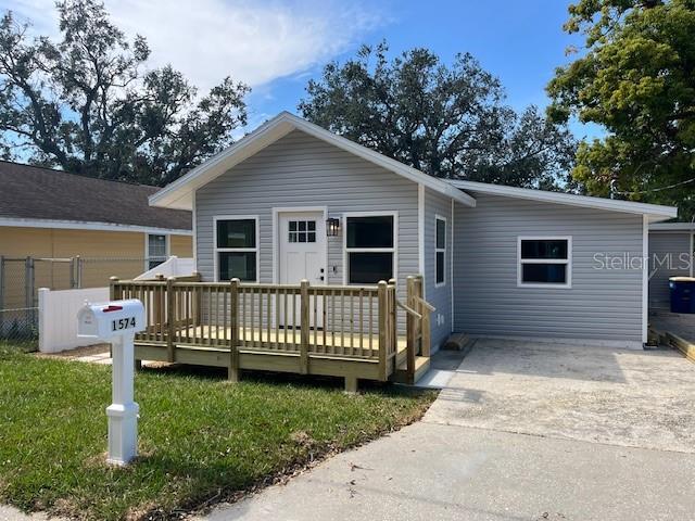 view of front of home with fence and a wooden deck