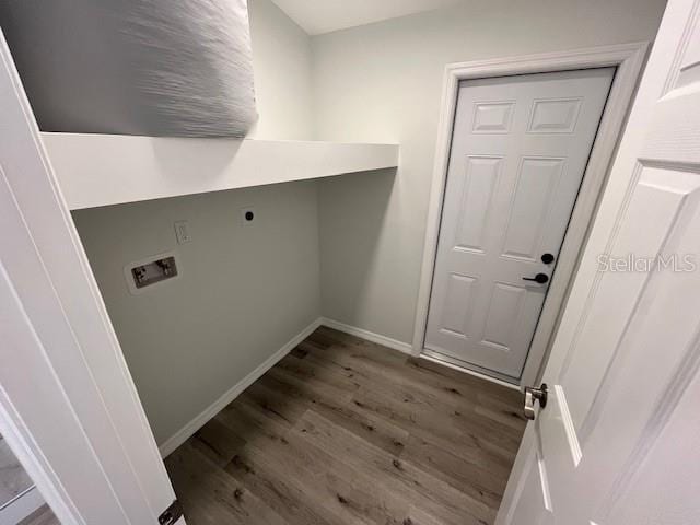 clothes washing area with baseboards, wood finished floors, laundry area, and hookup for a washing machine