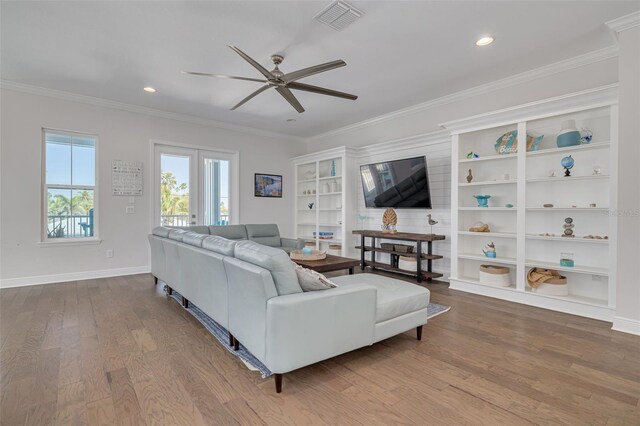 16306 1st St E, Redington Beach, FL 33708 - living room featuring wood finished floors, ornamental molding, ceiling fan, and visible vents
