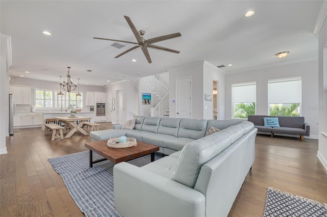 16306 1st St E, Redington Beach, FL 33708 - living room featuring recessed lighting, ornamental molding, stairs, and wood finished floors