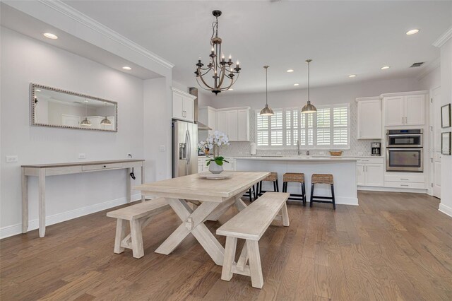 16306 1st St E, Redington Beach, FL 33708 - dining space with recessed lighting, ornamental molding, dark wood-type flooring, and a chandelier