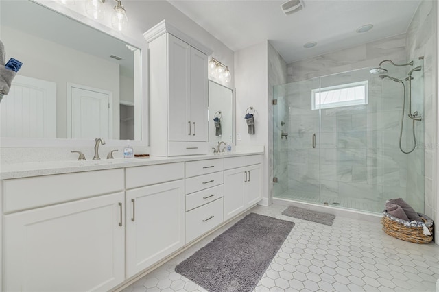 16306 1st St E, Redington Beach, FL 33708 - full bath with visible vents, a sink, double vanity, and a shower stall