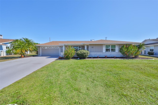 ranch-style home featuring concrete driveway, a garage, and a front lawn