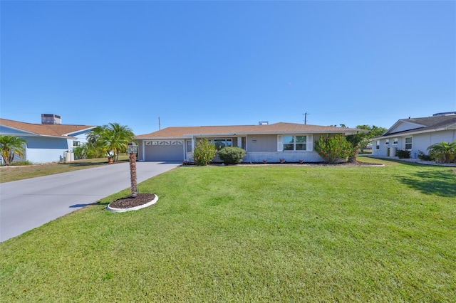 single story home with driveway, an attached garage, and a front yard