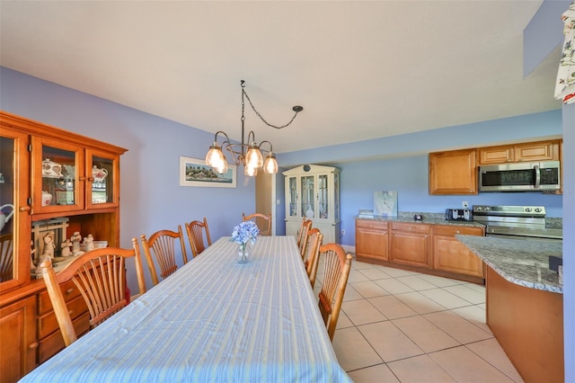 607 Fox Hills Dr, Sun City Center, FL 33573 - dining room featuring a chandelier and light tile patterned floors