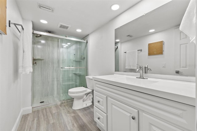 1998 Blue Hawk Ct Unit 1613, Clearwater, FL 33762 - bathroom with vanity, a stall shower, toilet, wood finished floors, and recessed lighting