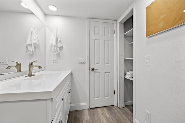 1998 Blue Hawk Ct Unit 1613, Clearwater, FL 33762 - bathroom with wood finished floors, baseboards, and vanity