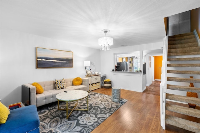 14019 Notreville Way, Tampa, FL 33624 - living room with stairs, a notable chandelier, and wood finished floors