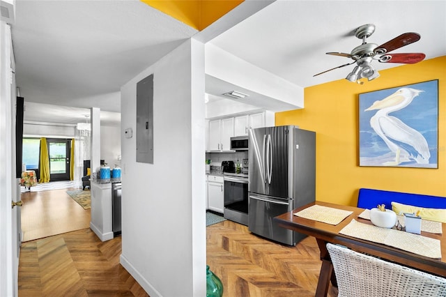 14019 Notreville Way, Tampa, FL 33624 - kitchen with visible vents, white cabinets, a ceiling fan, appliances with stainless steel finishes, and electric panel