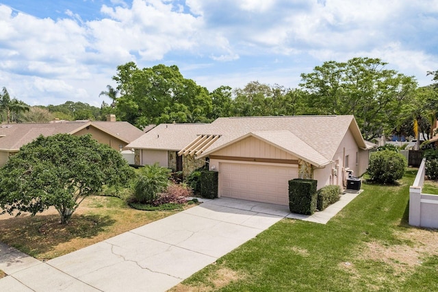 3388 Tarpon Woods Blvd, Palm Harbor, FL 34685 - view of front of house with a garage, concrete driveway, a front yard, central AC unit, and roof with shingles