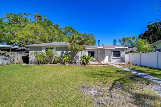 804 Shore Dr W, Oldsmar, FL 34677 - view of front of house featuring a front yard, stucco siding, and fence private yard