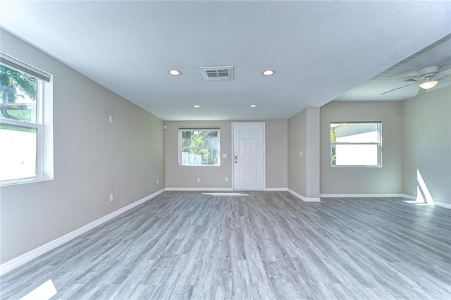 804 Shore Dr W, Oldsmar, FL 34677 - empty room featuring baseboards, a textured ceiling, light wood-style flooring, and visible vents