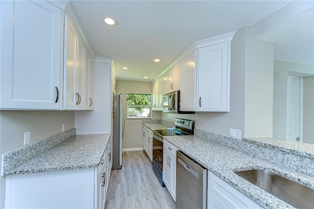 804 Shore Dr W, Oldsmar, FL 34677 - kitchen with white cabinets, stainless steel appliances, recessed lighting, and light stone counters