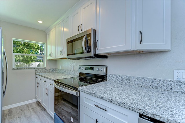 804 Shore Dr W, Oldsmar, FL 34677 - kitchen featuring baseboards, appliances with stainless steel finishes, white cabinetry, light wood-style floors, and light stone counters