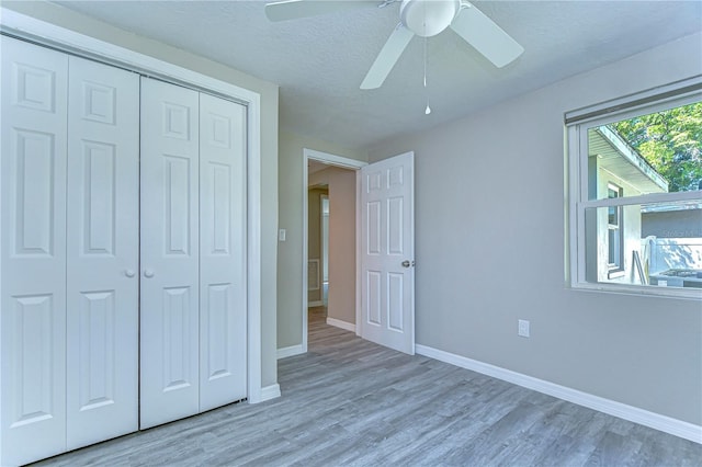 804 Shore Dr W, Oldsmar, FL 34677 - unfurnished bedroom with a closet, baseboards, wood finished floors, and a ceiling fan