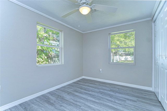 804 Shore Dr W, Oldsmar, FL 34677 - unfurnished room featuring a ceiling fan, crown molding, baseboards, and wood finished floors