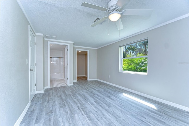 804 Shore Dr W, Oldsmar, FL 34677 - unfurnished bedroom featuring baseboards, crown molding, wood finished floors, and a textured ceiling