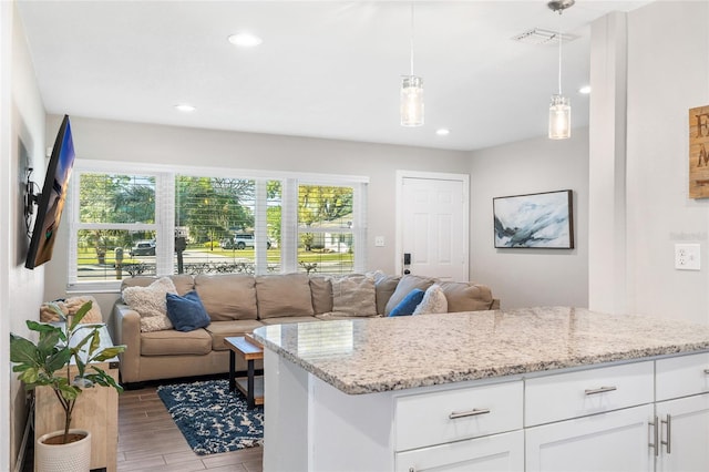 interior space featuring recessed lighting, wood finished floors, and visible vents