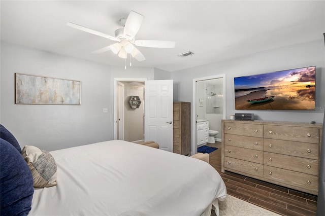 bedroom featuring ceiling fan, dark wood-type flooring, ensuite bath, and visible vents
