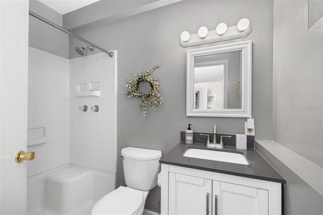 bathroom with vanity, walk in shower, and toilet