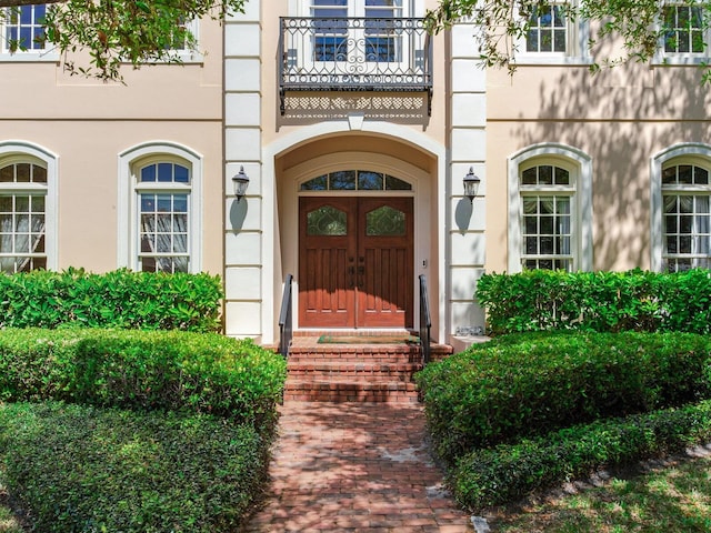 doorway to property featuring stucco siding